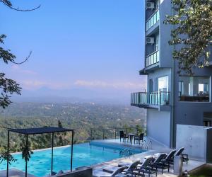 a patio with a view of the ocean and mountains at Mount Blue Kandy in Kandy
