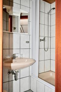 a bathroom with a sink and a shower at Gästehaus Steuer in Bruttig-Fankel