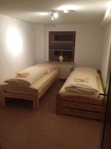 two twin beds in a room with a window at Knüllhotel Tann-Eck in Knüllwald