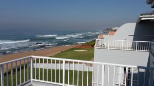 a balcony with a view of the ocean at Howela Beach House in Ballito +6 photos