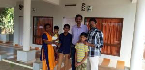 a group of people standing in front of a house at Quadriya Palace in Thekkady