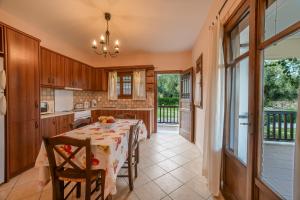 a kitchen and dining room with a table and chairs at Anna Apartments in Lithakia