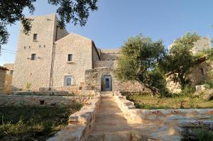 an old stone building with a staircase leading up to it at Antares Mani in Areopoli