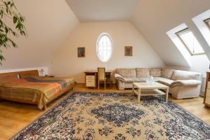 a attic bedroom with a bed and a couch at Villa A. Malka in Poděbrady