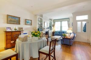a living room with a table with flowers on it at Fulham B&B in London