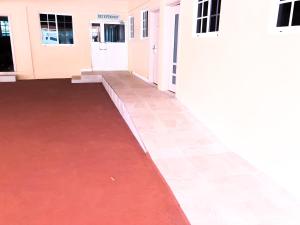 a corridor of a building with a red carpet at Calliandras Apartment Complex in Kingstown