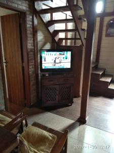 a tv sitting on a stand in a living room at El Repecho in Piriápolis