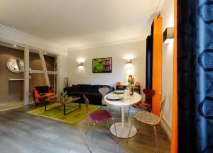 a living room with a table and chairs at Les Balcons du Rohan - Hypercentre - Vue sur le Château des Rohan in Saverne