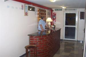 a man standing at a bar in a restaurant at Hotel Cosme in Buenos Aires