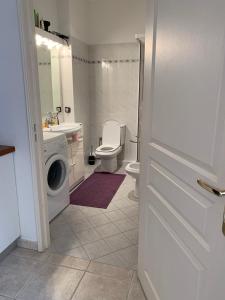 a bathroom with a toilet sink and a washing machine at Hyper Centre Place Massena in Nice