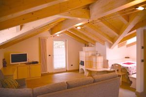 a living room with a couch and a table at Chalet Villa Bianca in Tesero