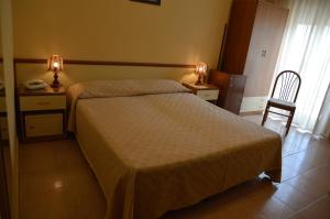 Postel nebo postele na pokoji v ubytování Hotel Virgilio