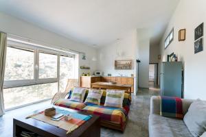 a living room with a couch and a table at Casa de los Olivos, 2 Hab 4 Pers Max in Puerto de la Laja