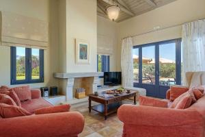 a living room with two couches and a fireplace at Villa Diamandi in Kaligata