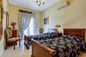 a bedroom with a bed and a chair and a window at Villa Kalithea in Argostoli +10 photos