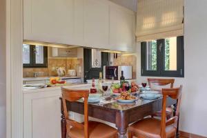 a kitchen with a table with food and drinks on it at Villa Riaki in Kaligata
