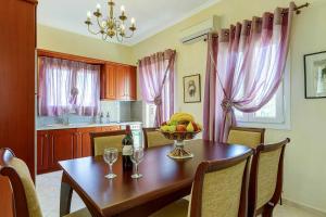 a kitchen with a table with a bowl of fruit on it at Villa Kalithea in Argostoli