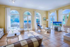 a living room with a couch and a tv at Villa Elpida in Sivota