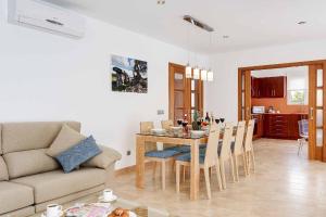 a living room with a table and a couch at Blue Dream in Cala en Forcat