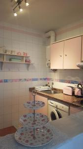 a kitchen with two tiers of dishes on a counter at Sol y Luz in Isla del Moral