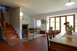 a living room with a staircase and a dining room at Bed and Breakfast da Käthy Agriturismo in Grono