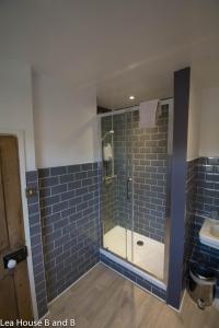 a bathroom with a shower and a sink at Lea House Bed and Breakfast in Ross on Wye
