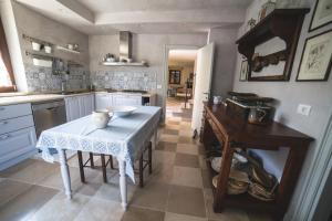 a kitchen with a table and a table and a counter at Casale Caldarette in Fermo