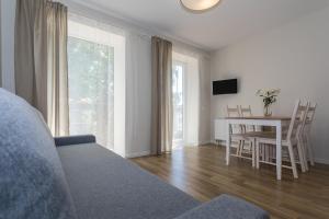 a living room with a table and a dining room at Liepų 16 in Palanga