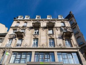 un grand bâtiment avec des fenêtres au-dessus dans l'établissement ibis Styles Strasbourg Centre Petite France, à Strasbourg