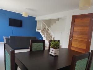 a dining room with a table and a staircase at Apart Porto del Sol by CPH in Villa Carlos Paz