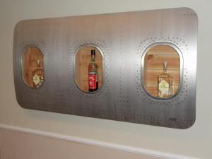 a wall with three bottles of alcohol on it at Großzügiges Appartement nähe Hannover-Messe in Hannover