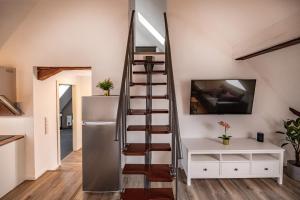 a spiral staircase in a room with a refrigerator at Ganze Wohnung in Bad Buchau am Federsee in Bad Buchau