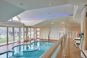 
a large swimming pool in a hotel room at Sir Sam's Inn & Spa in Haliburton
