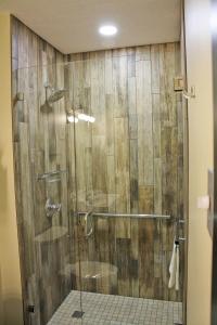 a shower with a glass door in a bathroom at The Rustic Suite - Main Street Lodge in Berlin in Berlin