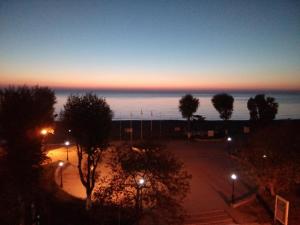 a view of the ocean at sunset from a building at Giorgos Apartments Sea View in Olympiaki Akti