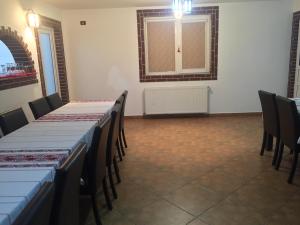 a room with tables and chairs and a window at Casa Ade in Slănic
