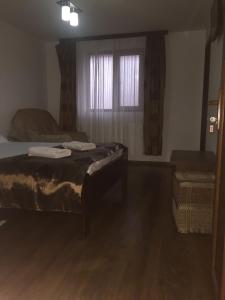 a living room with two beds and a window at Casa Ade in Slănic