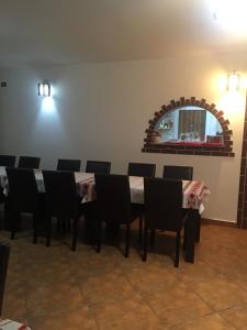 a dining room with a table and chairs at Casa Ade in Slănic +18 photos