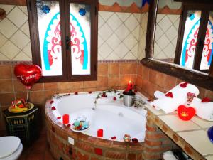 a bathroom with a bath tub in a room with windows at Apartamentos La Suerte in Hinojares +155 photos
