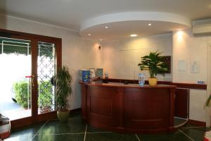 a lobby with a reception counter in a room at Residence Elvira in Diano Marina