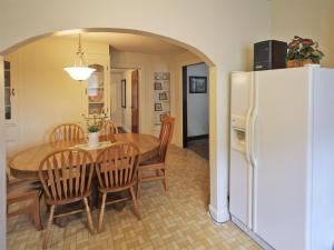 a kitchen and dining room with a table and a refrigerator at Historic Raber House in Berlin
