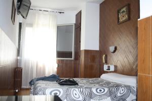 Postel nebo postele na pokoji v ubytování Hostal Sanmar