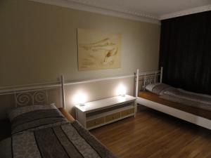 a bedroom with two beds and two lights on the wall at Großzügiges Appartement nähe Hannover-Messe in Hannover