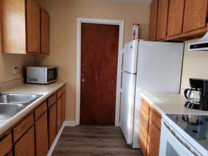 a kitchen with a white refrigerator and a microwave at Cozy and Spacious-4 Bedrooms Townhouse in Lexington +8 photos