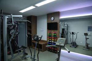 a gym with treadmills and machines in a room at Hotel Maysa Caruaru in Caruaru