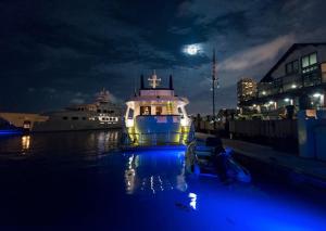 a boat is docked in the water at night at Boston Yacht Haven in Boston