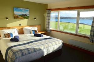 A bed or beds in a room at St Columba Hotel