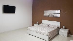 Łóżko lub łóżka w pokoju w obiekcie A casa di Pamy
