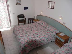 Postel nebo postele na pokoji v ubytování Hotel Vecchia Rimini