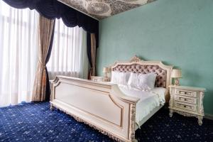 a bedroom with a white bed and a green wall at JMR Royal in Constanţa
